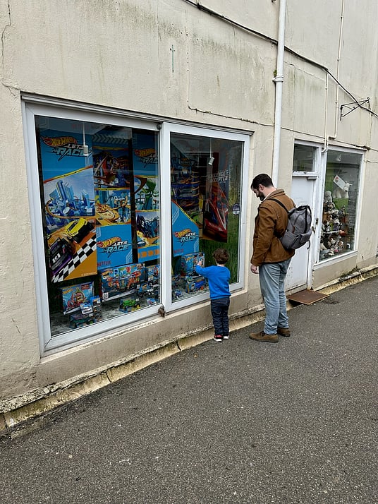 William and I staring at Hot Wheels in the window of a toy shop.